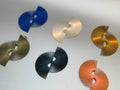 Assorted fan-shaped modern earrings in blue, gold, cream, green, and coral on white surface