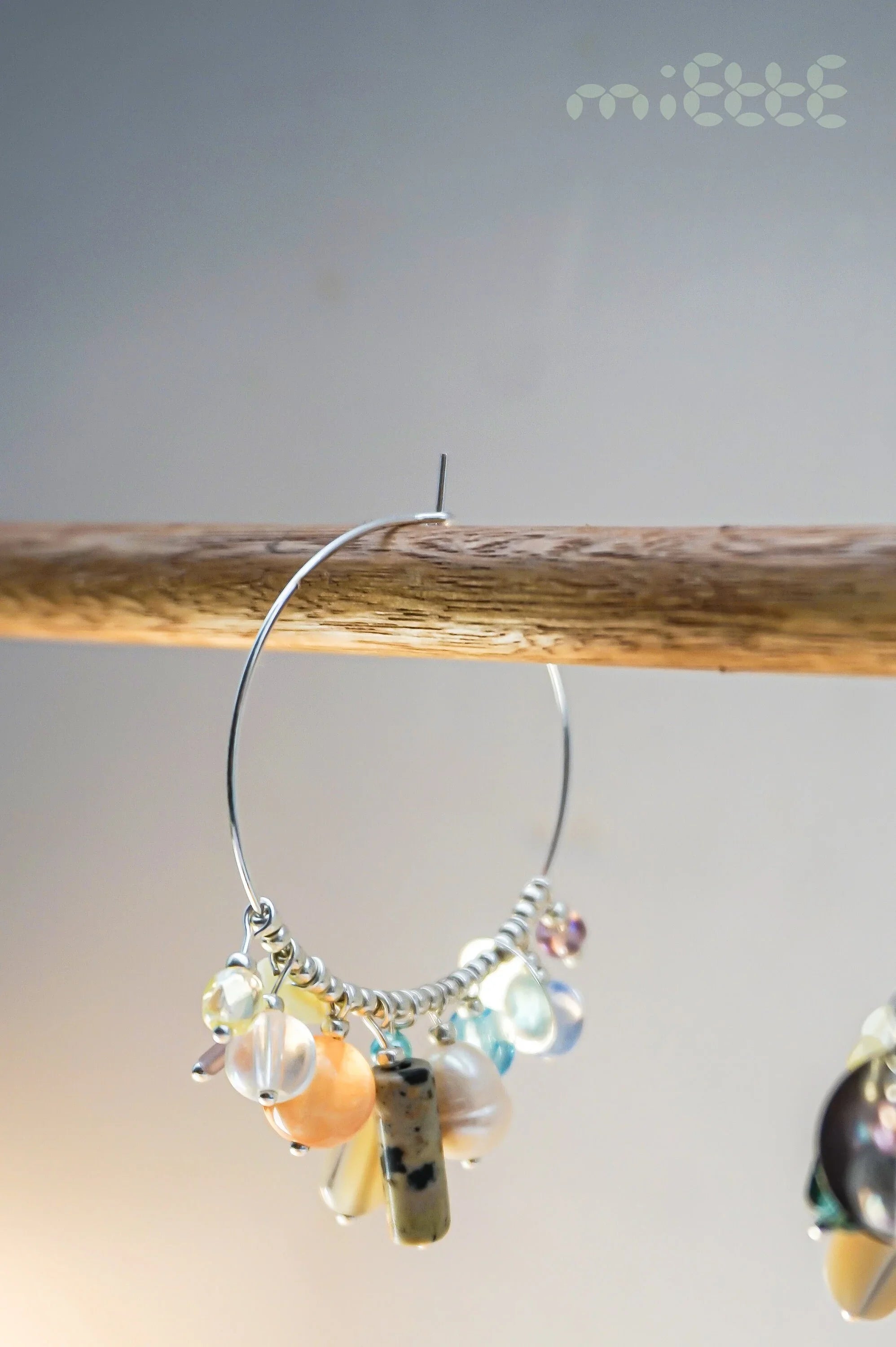 Handcrafted hoop earring with multicolored gemstone and pearl charms on metal wire