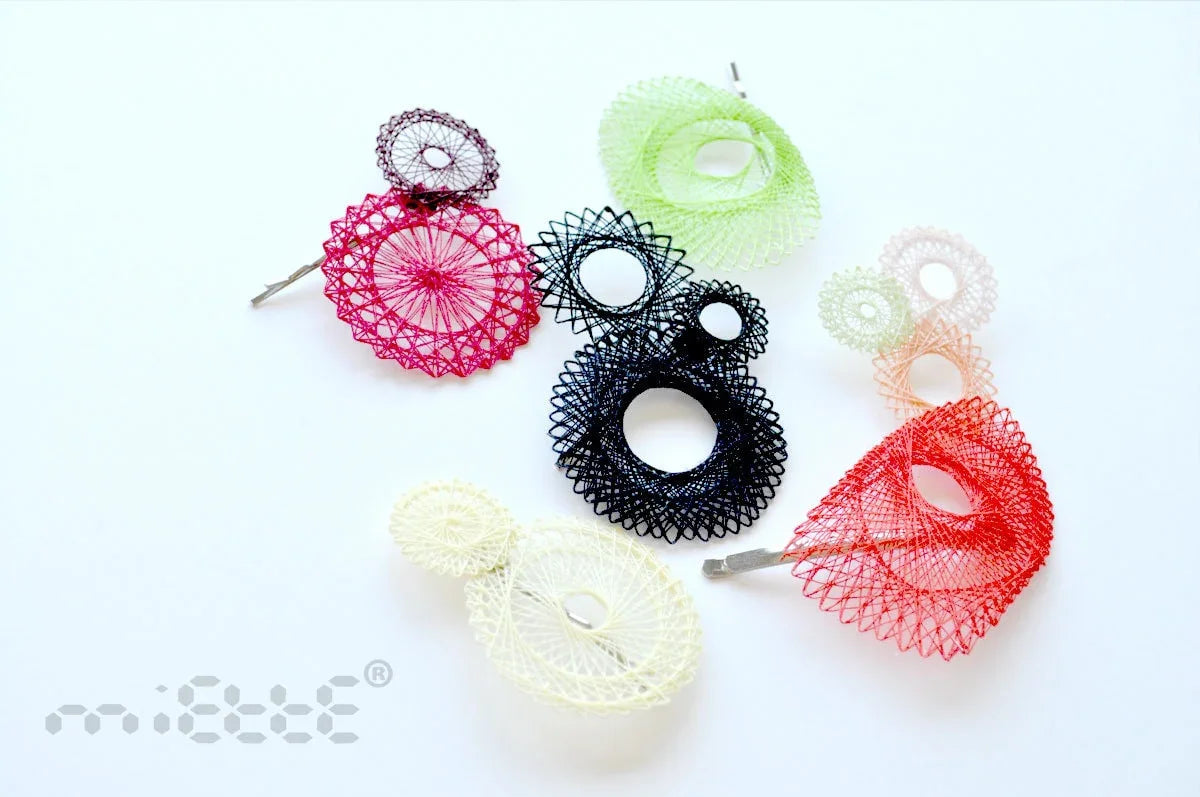 Colorful geometric lace hair barrettes in circular and spiral designs on white background